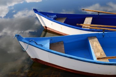 Small white and blue wooden boats clipart