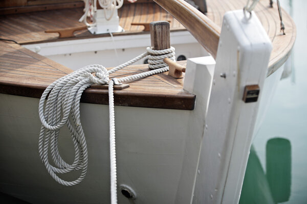 Close view on rope and helm of a sailing boat