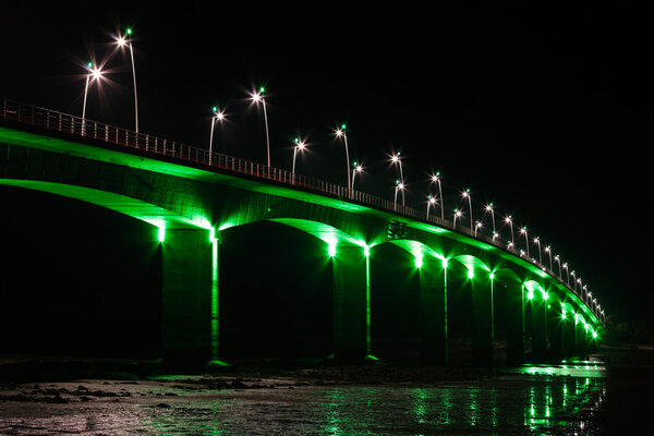 Viaduct under green lights