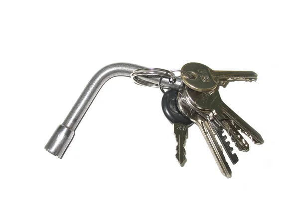Sheaf of keys on iron ring on white — Stock Photo, Image