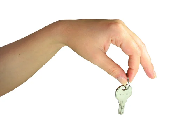 Vrouw hand geven de sleutel geïsoleerd — Stockfoto