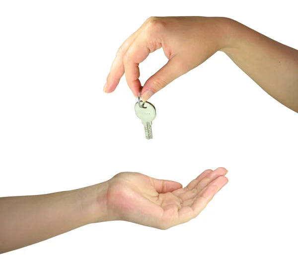 Twee vrouw handen geven de sleutel — Stockfoto