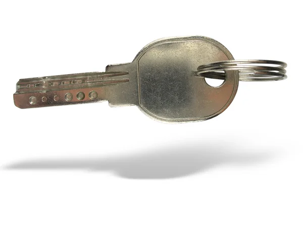 Metallic key with ring and shadow — Stock Photo, Image