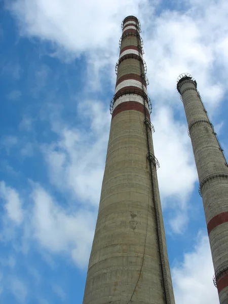 Two chimneys on the cloudy sky — Stock Photo, Image