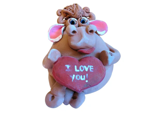 Vache avec figurine en argile coeur — Photo