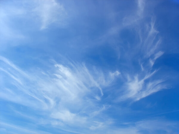 Blue summer sky and white high cirrus fluffy clouds
