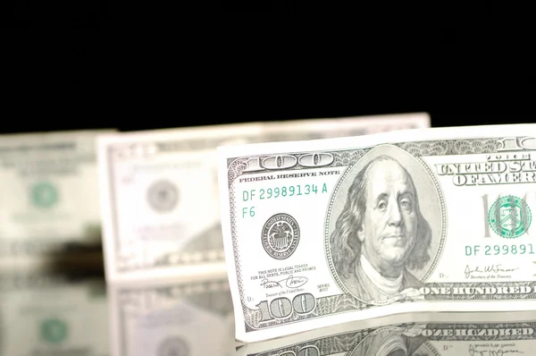 One hundred dollar bills on the black background — Stock Photo, Image