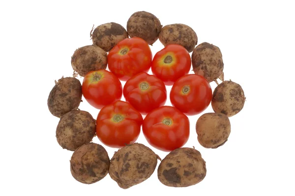 Haufen Kartoffeln und Tomaten — Stockfoto