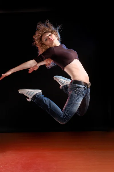 Jumping girl on the black background — Stock Photo, Image