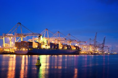 Container terminal at night clipart