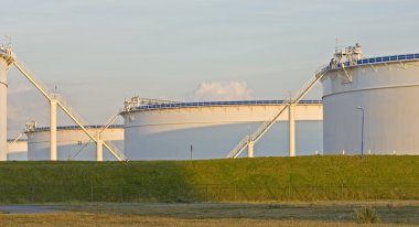 Oil tanks in the evening light clipart