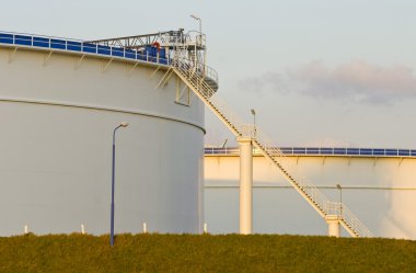 Oil tanks in the evening light clipart