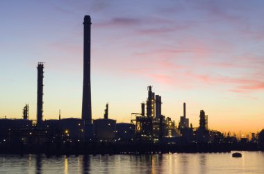 Oil Refinery at sunset clipart