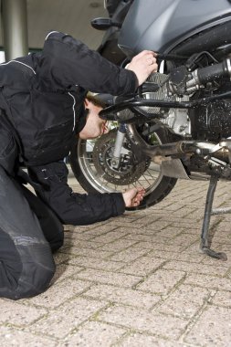 Checking the oil level of a motorcycle clipart