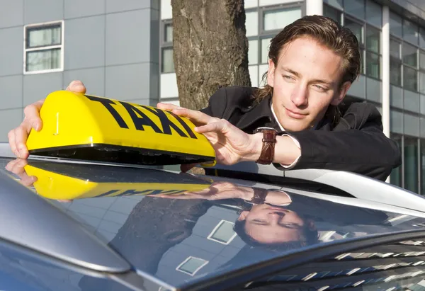 Placing the Taxi sign — Stock Photo, Image