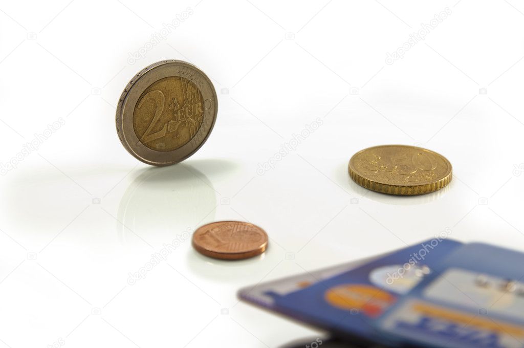 Euro coins and blurred credit cards