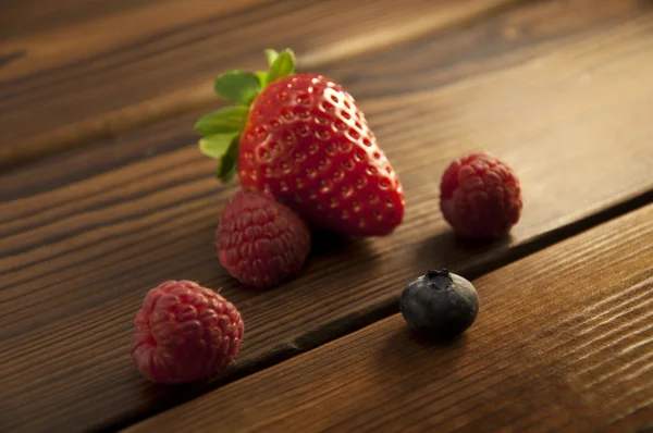 Berries on an old wood background — Stock Photo, Image