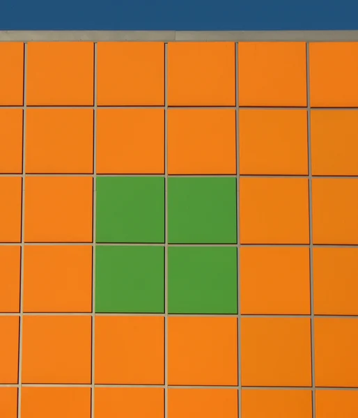 stock image Wall, faced with orange and green tiles