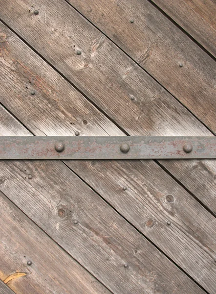 Old wooden door with an iron strip Stock Photo