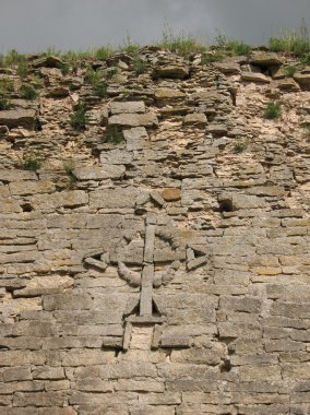 Cross on the wall of Izborsk fortress clipart