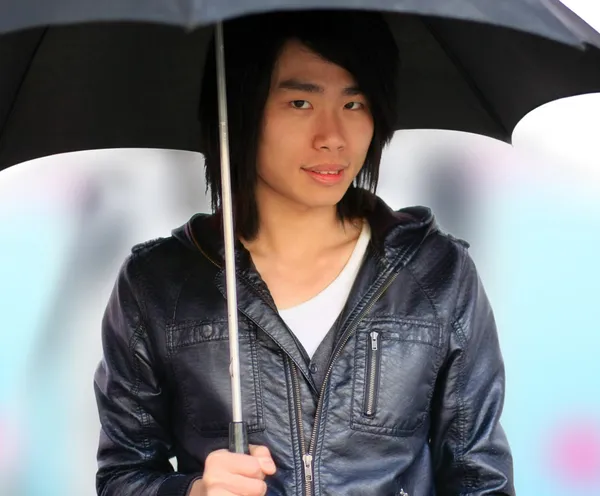 Autumn Asian man with umbrella — Stock Photo, Image