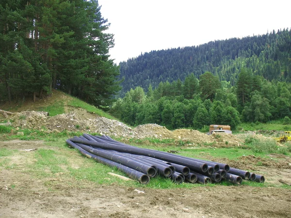 Warehouse of pipes on a glade — Stock Photo, Image