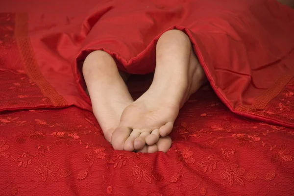 Женские ноги в постели — стоковое фото