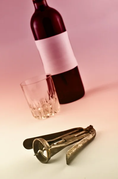 Wine bottle and metal corkscrew — Stock Photo, Image