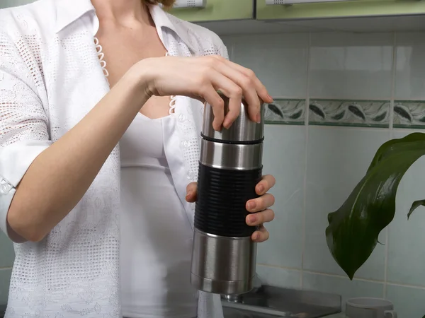 Thermos in hands — Stock Photo, Image