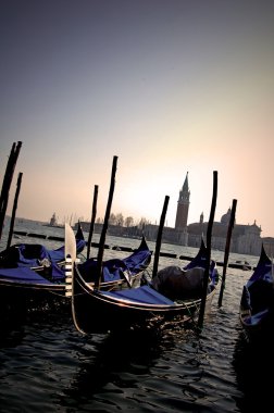 Sunset and gondolas in Venice clipart