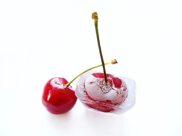 Two sweet cherries, one in ice — Stock Photo, Image