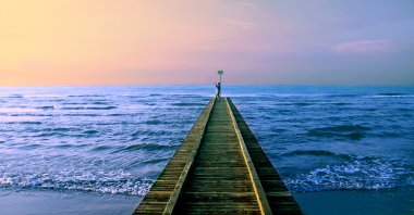 The man photographs sunrise on the sea clipart