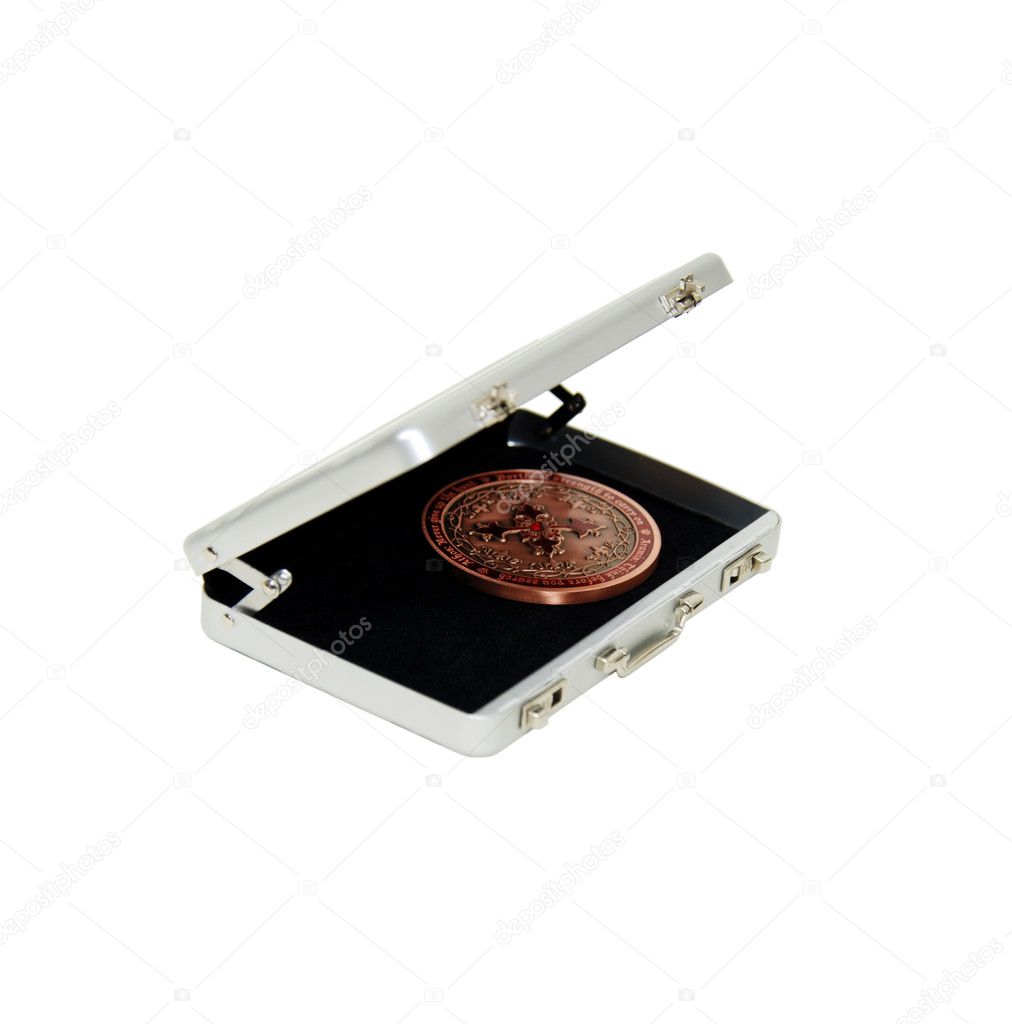 Intricate coin in silver briefcase