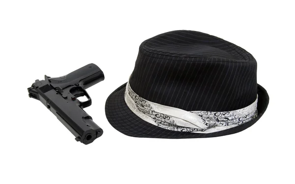 Černý plstěný klobouk a zbraň — Stock fotografie
