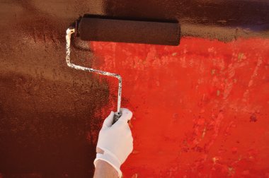Painting Sailboat Hull with a Roller clipart