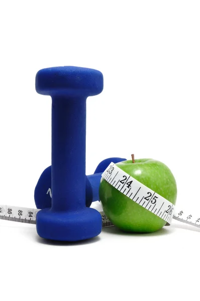 Meetlint, gewichten en groene appel — Stockfoto
