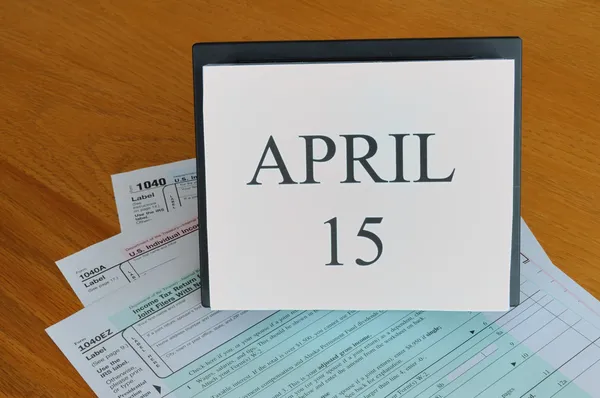 stock image April 15 on calendar, 1040 tax forms