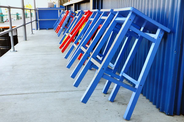 stock image Red and Blue Stools Leaning Against Bar