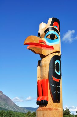 Eagle Totem Pole Against a Blue Sky clipart