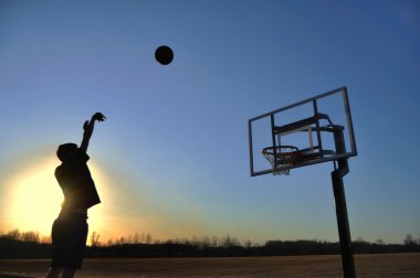 Silhouette of Teen Boy & Basketball clipart