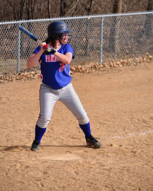 Teen Girl Softball Player Batting clipart