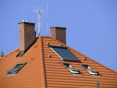 Roof with two chimneys and solar panel clipart