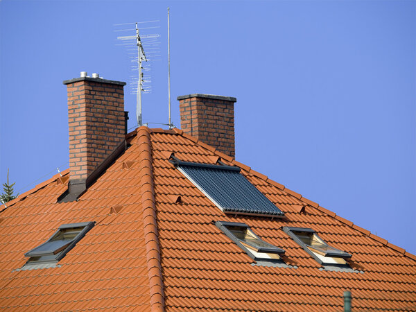 Roof with two chimneys and solar panel