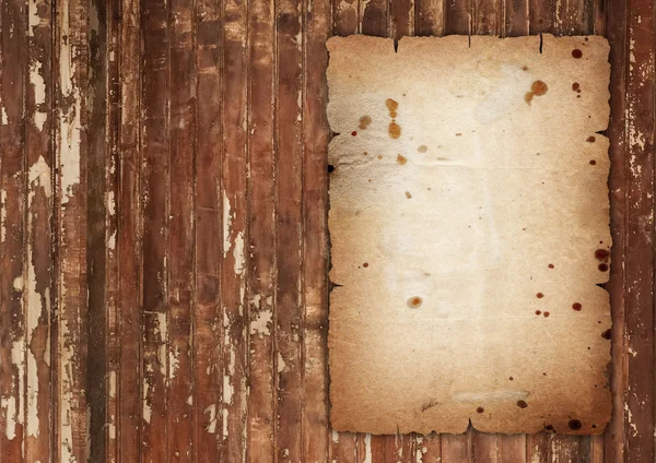Old wrinkled paper on wood — Stock Photo, Image