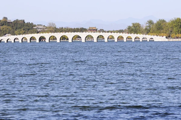 stock image Long stone bridge in Chinese park