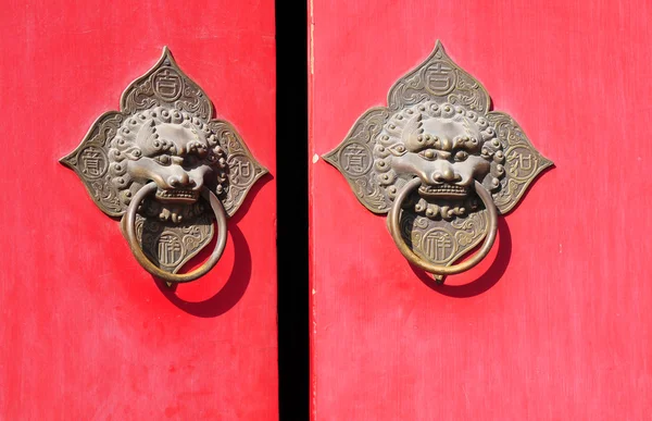 stock image Red door with lion statue