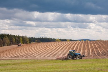 Tractor plowing filed clipart