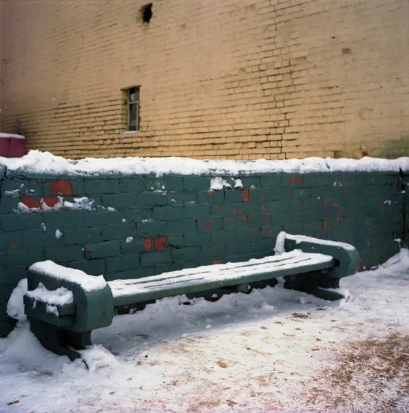 Stock image Alone wooden bench, urban view