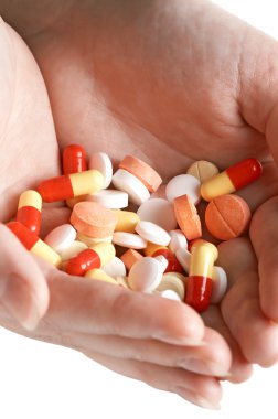 Heap of pills in two woman hands clipart