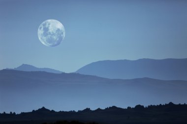 Ghostly Mountain Silhouettes and Moon clipart